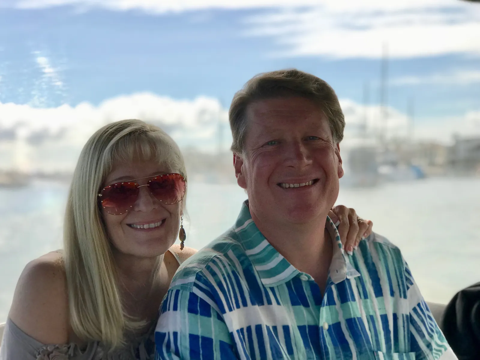 Mary Purkiss and Ed Purkiss, Foxie's founders, on a boat on a sunny day