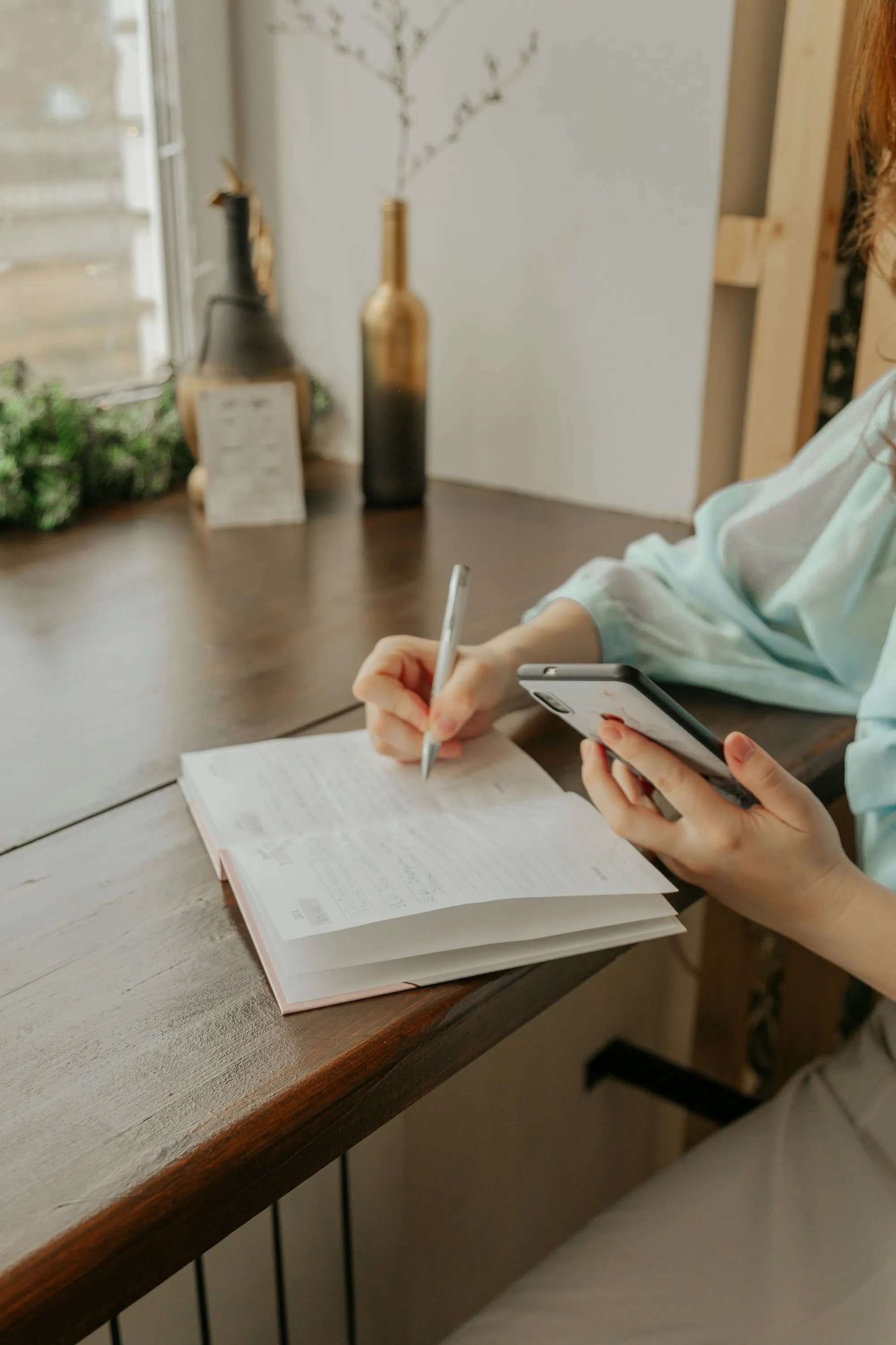 A planner at a table, notebook open